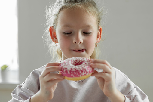 Girl eating unhealthy donut