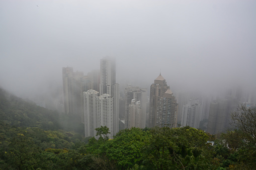 Hong Kong - February 22, 2015: Hong Kong covered in fog as seen from The Peak.