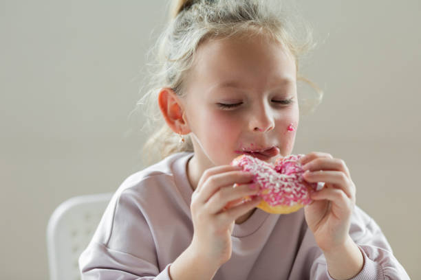 Girl eating unhealthy donut