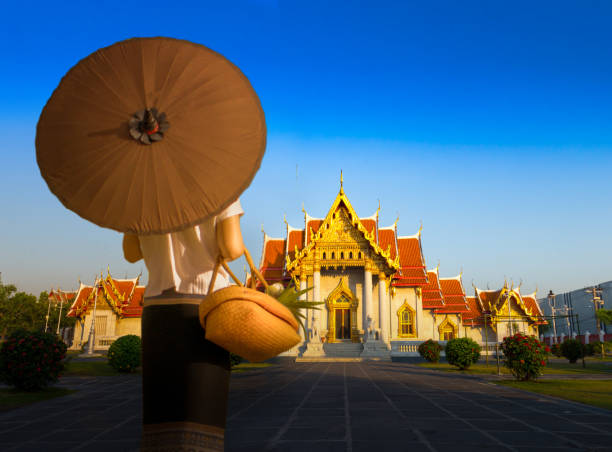 Thailand A Thai Buddhist woman go to temple in the morning at Bangkok, Thailand. grand palace bangkok stock pictures, royalty-free photos & images