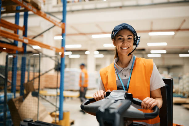 istock Happy female warehouse worker looking at camera. 1396631608