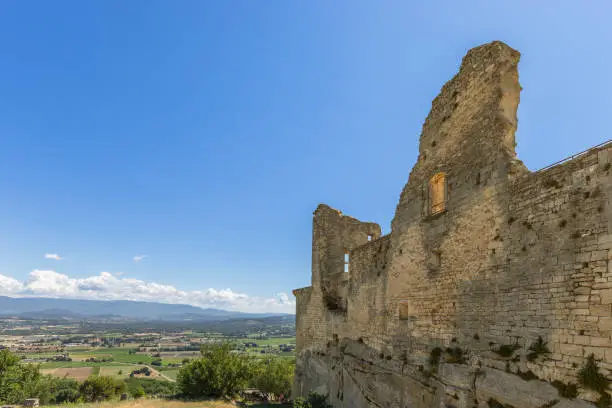 Photo of Ruins of Chateau du Marquis de Sade, overview to Calavon valley on sunny summer day, Vaucluse, France