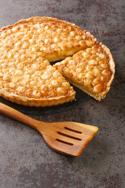 istock Tart with macadamia nuts and custard close-up on a slate board. vertical 1396633325