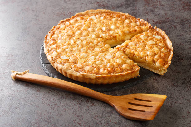 istock Sliced delicious nut shortcrust tart with caramel close-up on the table. horizontal 1396633506