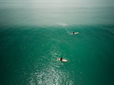 Cagliari, Italy – April 16, 2022: two surfers waiting the right wave - Surf Aerial Shot - Poetto beach - Sardinia
