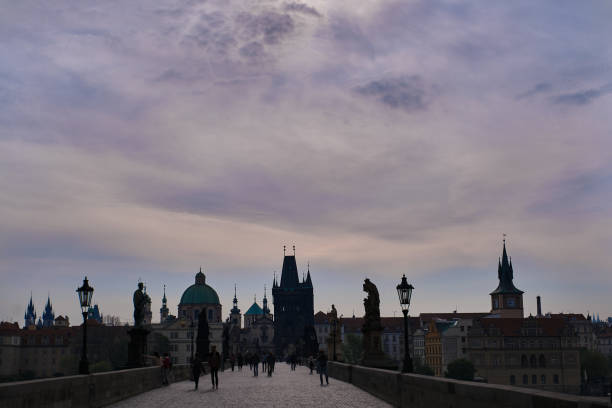 Morning walk over the Charles bridge View of the Old town from Charles bridge with its silhouette of churches and towers. old town bridge tower stock pictures, royalty-free photos & images