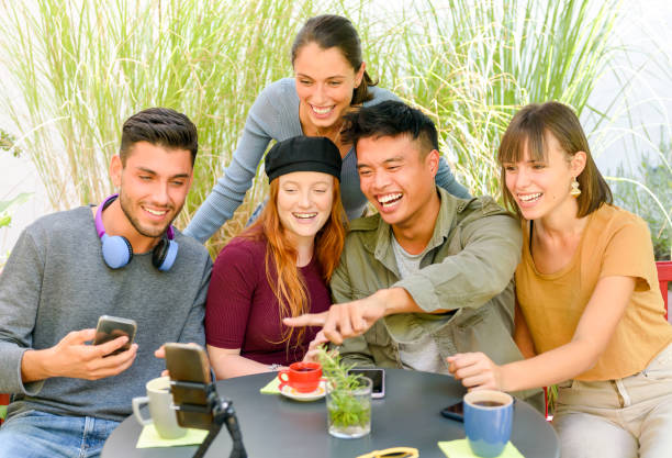 istock Glad multiracial friends having a video call in cafeteria 1396635893