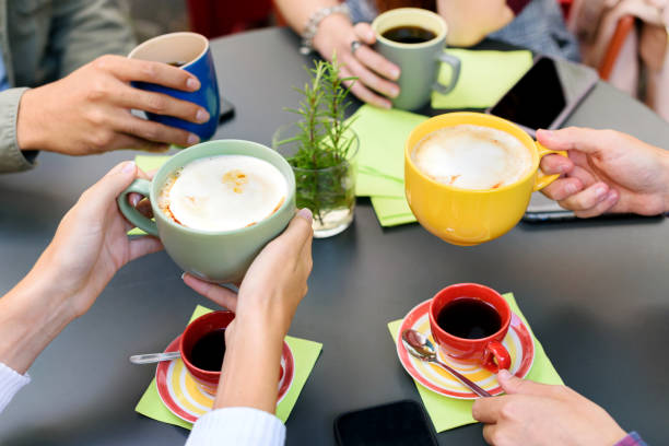 istock Anonymous friends drinking coffee in cafe 1396635899