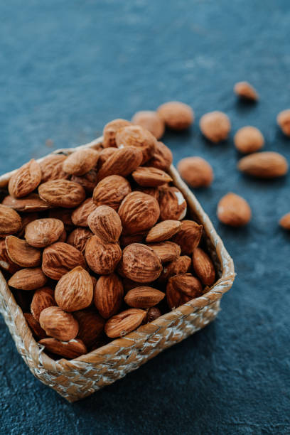 istock some shelled almonds in a square palm basket 1396636762