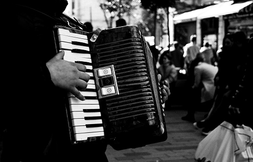 Rome, Italy, April 09 -- A group of street musicians play along Ponte Sisto, in the ancient Trastevere district, at the time of Covid-19. Trastevere is one of the most iconic district of the eternal city, for the presence of monuments and ancient churches, but also for small squares and alleys where it is easy to find typical restaurants, pubs and little store. Image in High Definition Format.