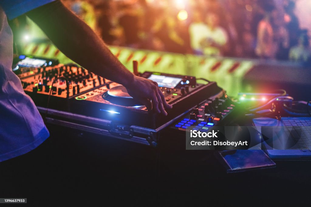 Dj mixing outdoor at party event - Entertainment concept - Soft focus on hand DJ Stock Photo