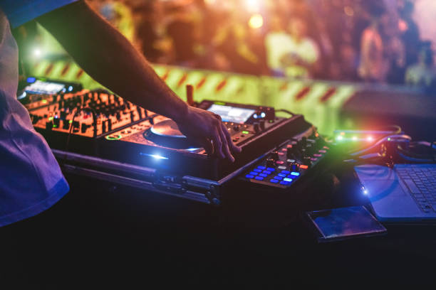 Dj mixing outdoor at party event - Entertainment concept - Soft focus on hand stock photo