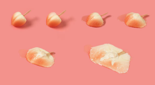 istock melting process of a beauty peach shape popsicle on pink  background 1396641168