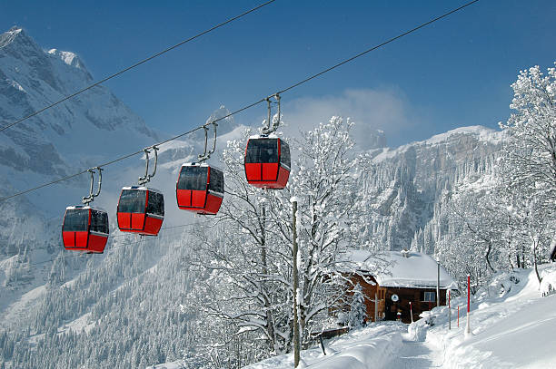 Tram cars over a snowy winter scene in the mountains stock photo