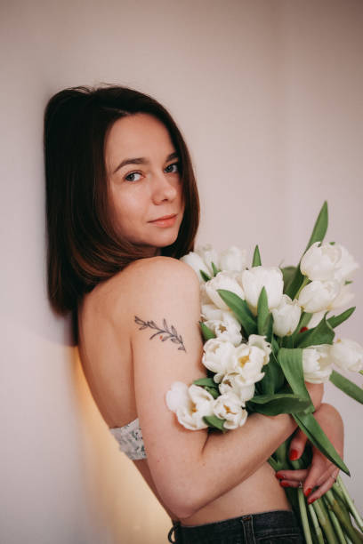 istock A beautiiful woman with tulip flowers 1396642087