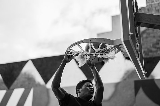 Young african man playing basketball outdoor - Focus on ball