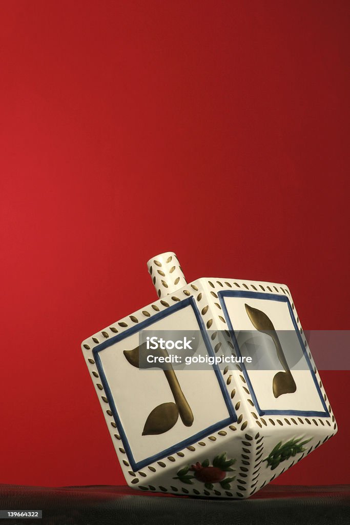 chanukkah dreidel clay chanukkah dreidel on red background Dreidel Stock Photo