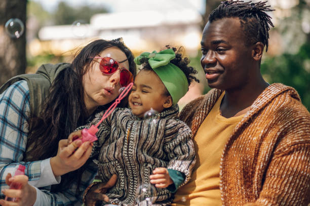 istock Multiracial family having fun in the park 1396643450