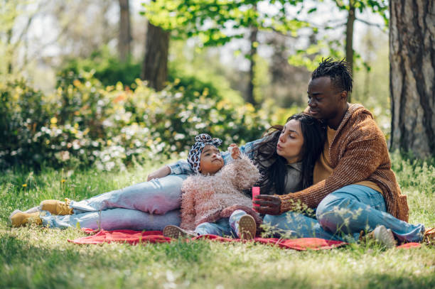istock Multiracial family having fun in the park 1396643463