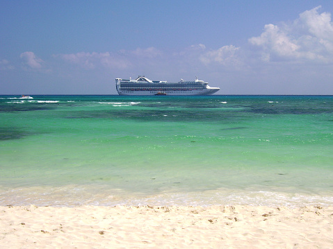 Cruise ship moored on the turquoise water off the coast at Playa del Carmen, a popular resort on the Caribbean Sea, Quintana Roo.
