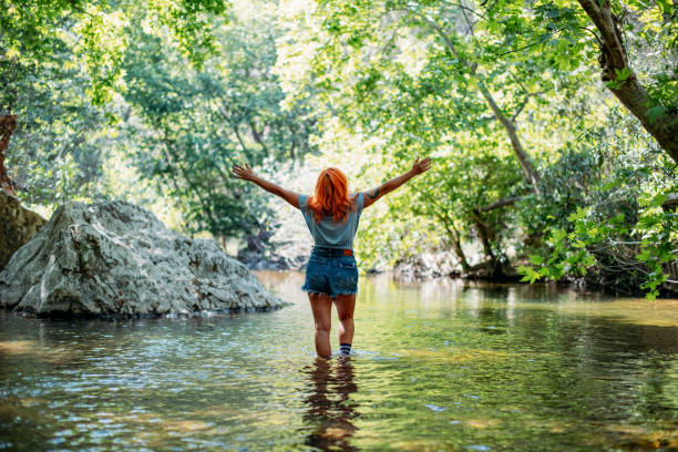 istock Beautiful Redhead Woman in the River 1396644278