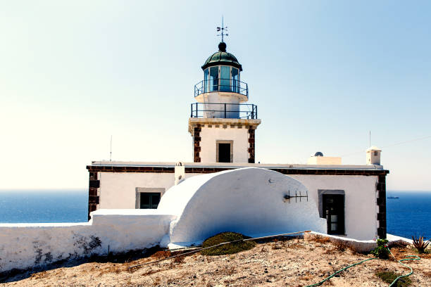 istock The old lighthouse on the rocky sea coast. Blue sky with clouds. 1396644418