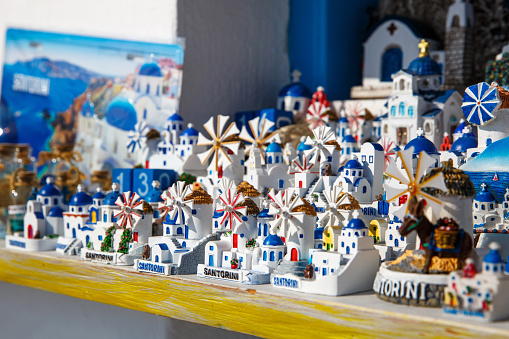 Windmills and churches - souvenirs on Santorini island, Greece