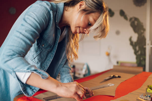 istock Woman tailor working from home and tailoring beautiful clothes 1396644735