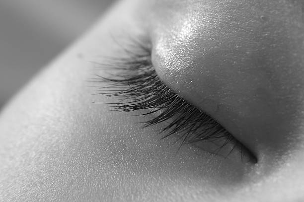 Blue eyes of a close-up boy look straight and in the side