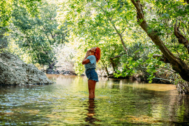 istock Beautiful Redhead Woman in the River 1396646547