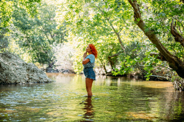 istock Beautiful Redhead Woman in the River 1396646618
