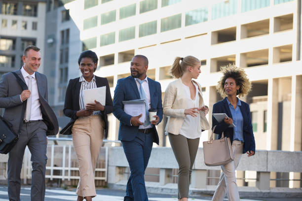 istock Colleagues walking in the city on their way to work 1396647170
