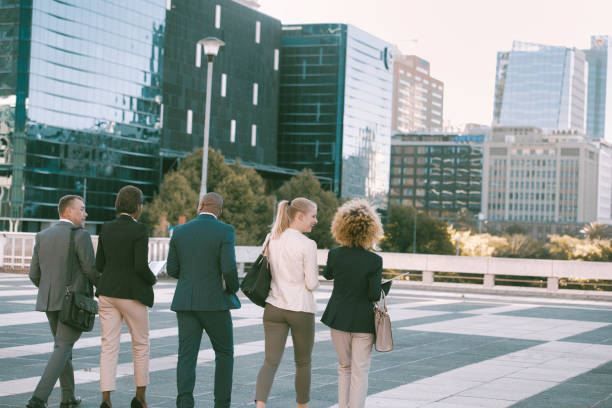 istock Back view of colleagues walking in the city 1396648283