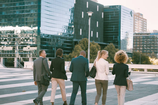 istock Back view of colleagues walking in the city 1396648285