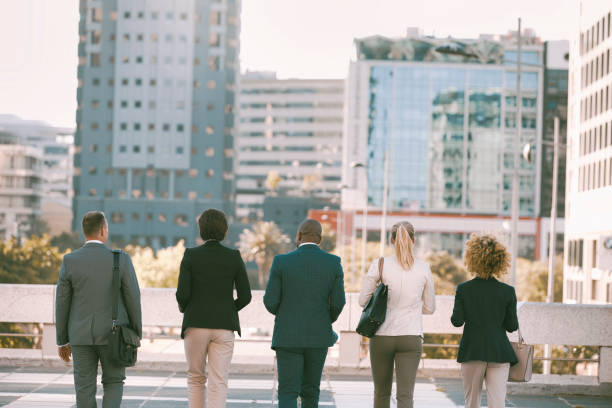 istock Back view of colleagues walking in the city 1396648286