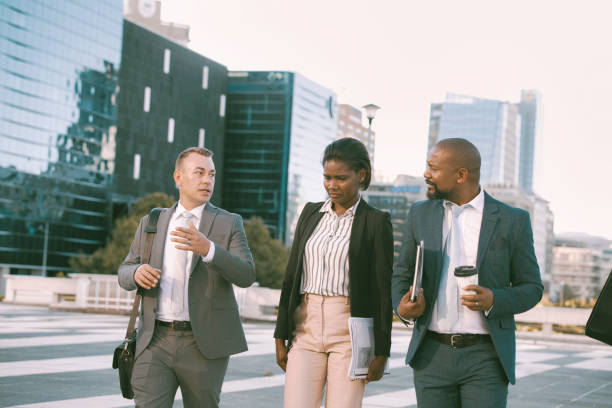 istock Colleagues walking in the city on their way to work 1396648416