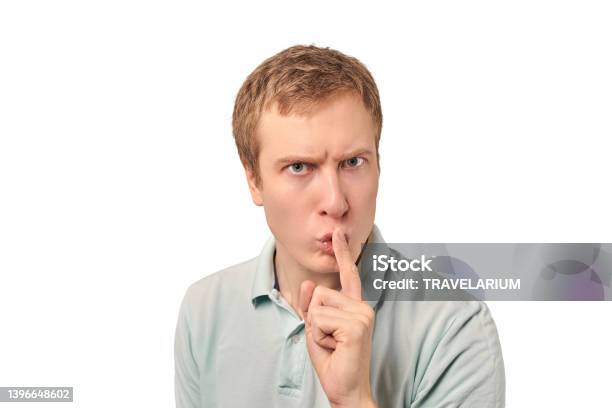 Funny Guy In Light Gray Polo Tshirt Asking To Be Quiet Silence Gesture White Background Stock Photo - Download Image Now