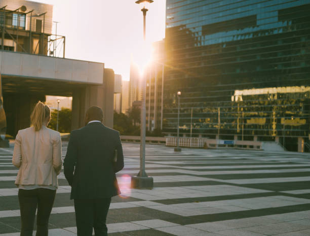 istock Rear view of two colleagues walking towards the sunset 1396648637