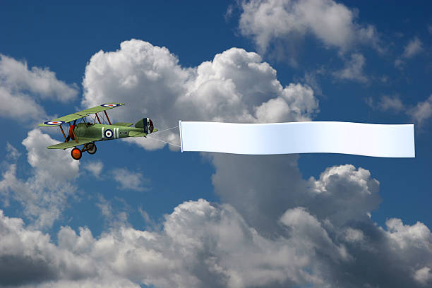 Biplane in Sky with Blank Banner stock photo