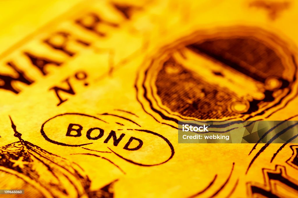 A close-up of the word bond with a yellow tint Vintage Bond - Background Bond - Financial Item Stock Photo A close-up of the word bond with a yellow tint Vintage Bond - Background Bond - Financial Item Stock Photo