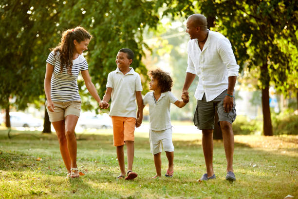istock Happy couple spending time with their sons in the park 1396651925