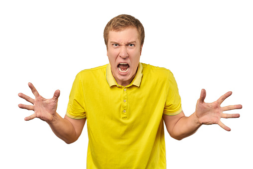 Angry guy in yellow T-shirt spread his hands and yelling isolated on white background. Yelling man in bright yellow T-shirt very angry and annoyed, relationship conflict, quarrel concept