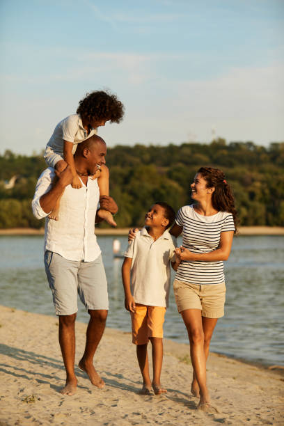 istock Beautiful family walking on the beach 1396654249