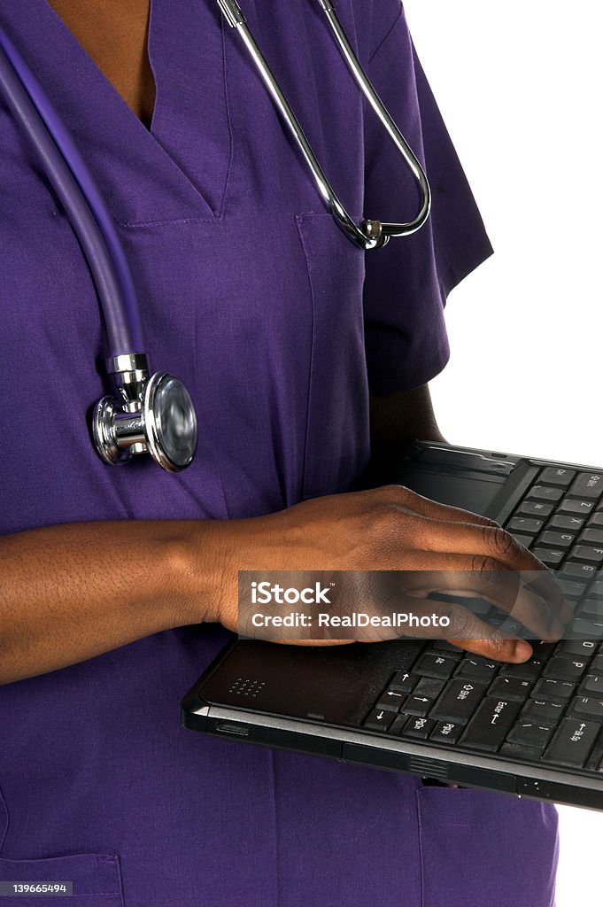 Medical Nurse Close up detail of the hand of an African American nurse with stethoscope and a notebook computer Adult Stock Photo