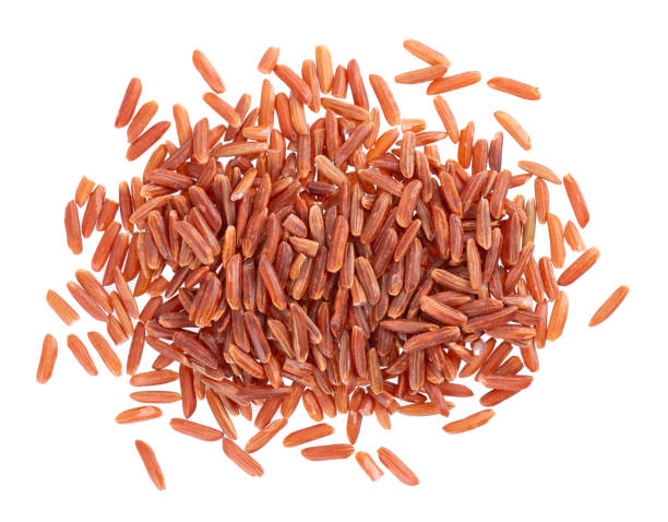istock Red rice isolated on white background. Whole grain raw brown rice. Top view. 1396658357