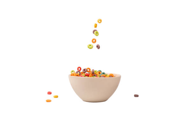Colorful cereal box for morning breakfast. Corn flakes falling to the white bowl. Motion.