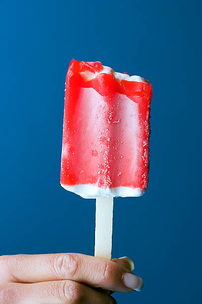 istock Female hand holding red popsicle 139665861
