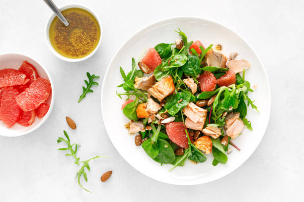 istock Grilled salmon salad with grapefruit, almonds and salad mix. Top view 1396661085
