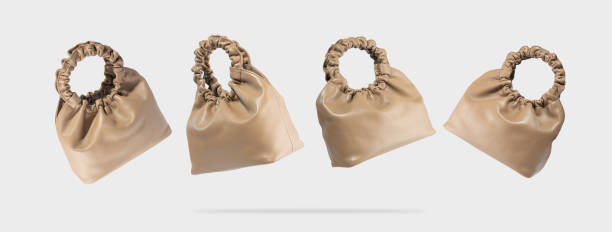 istock A brown eco leather bags from different sides flying on a gray background.Creative composition of a levitating handbag.Conceptual banner of fashionable women's accessories.Handmade vegan friendly bag 1396661152