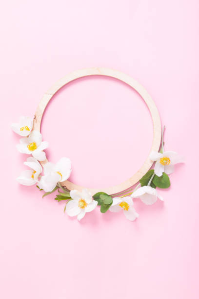 istock Summer or spring composition on a pink background. Wooden frame with anemone flowers with copy space. Summer, spring floral concept 1396669132
